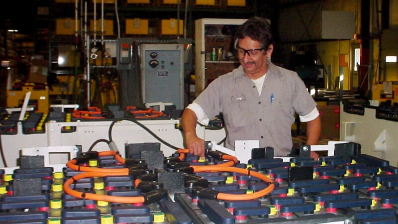 A worker with FLA & AGM batteries